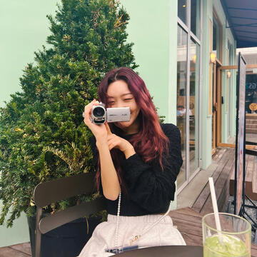 minji (secret number) laughing holding camera